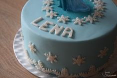 a frozen princess birthday cake with frosting and snowflakes on the bottom layer