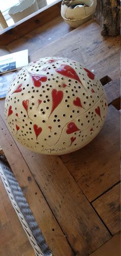 a white and red object sitting on top of a wooden table