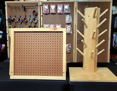 two pieces of wood are on display at a craft fair, one is made out of plywood and the other has pegboard