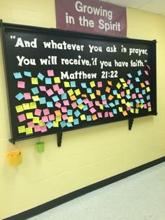 a bulletin board with sticky notes on it in a school hallway that reads and whatever you ask in prayer