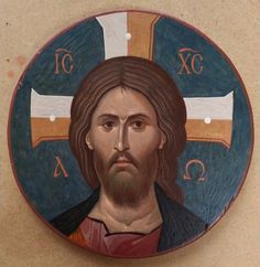 a painting of jesus on the side of a wall with crosses in it's center