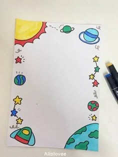 a white paper with space and stars on it next to a black marker, pen and eraser