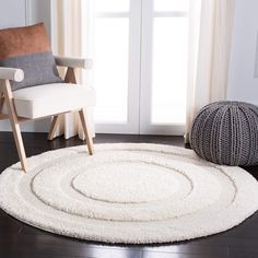 a living room with a chair and rug