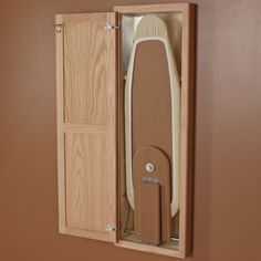 a wooden box with a surfboard in it and its door open to show the inside