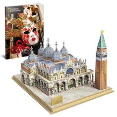 a paper model of a building with a clock tower in front of it and a book about venice