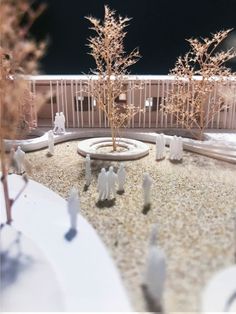 a miniature garden with trees and people in it