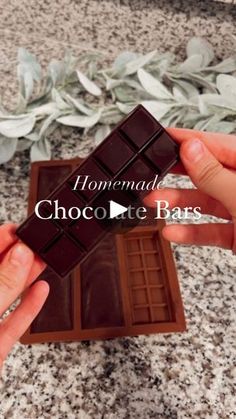 someone holding a chocolate bar in their hand with the words homemade chocolate bars on it