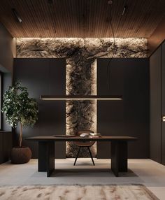 a modern dining room with black walls and wood flooring, along with a rug on the floor