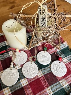 some ornaments are sitting on a plaid table cloth