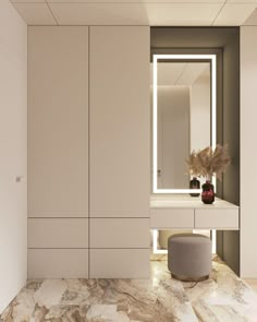 a bathroom with marble counter tops and white cabinets, along with a round stool in front of the mirror