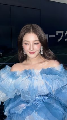 a woman in a blue dress posing for the camera