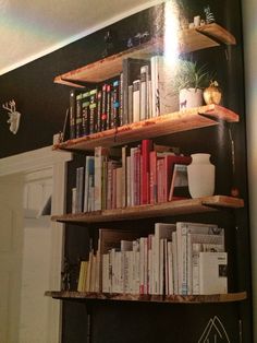 a bookshelf filled with lots of books in a room