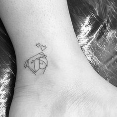 a small black and white tattoo on the ankle