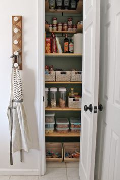 an open pantry door with spices and other items in it