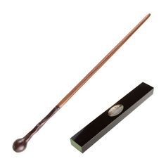 a wooden stick with a handle on it next to a black box