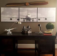 an airplane is on the wall above a desk