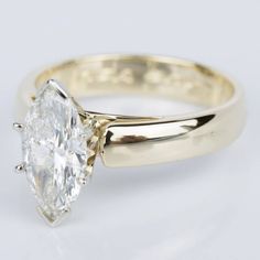 an engagement ring with a pear shaped diamond