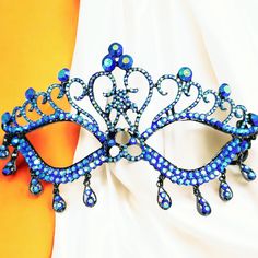 a blue masquerade on an orange and white background