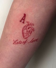 a small tattoo on the leg of a person with a heart and letters that read, taste of love