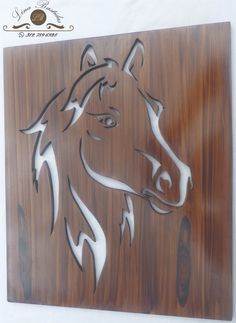 the horse is made out of wood and has white paint on it's face