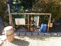 an outdoor play area in the middle of a yard with rocks and gravel around it