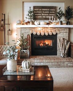 a living room filled with furniture and a fire place in the middle of the room