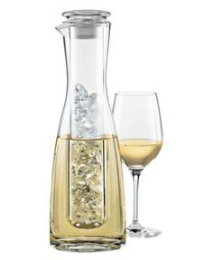 a wine decanter with a glass next to it