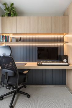 an office with a desk, chair and computer on top of the desk is lit by recessed lighting