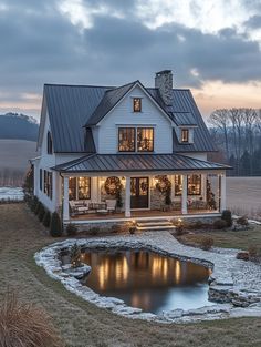 a house with a pond in the front yard