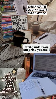 an open notebook sitting on top of a table next to a pile of books and papers