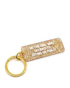 a gold keychain that says, be the girl who decided to definate it