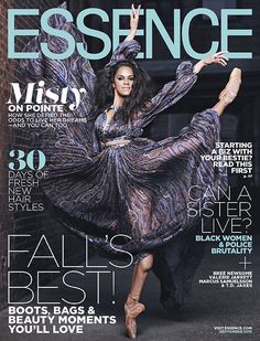 a woman in a dress on the cover of an issue of essence magazine, with her legs spread out