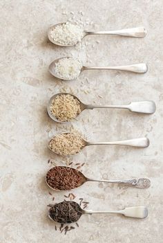 five spoons with different types of rice in them