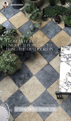 an overhead view of a tiled patio with potted plants on the floor and a bench in the middle