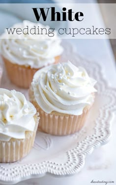 three cupcakes with white frosting on a plate