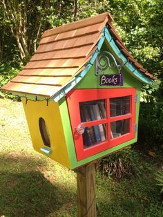 a colorful bird house with books in it