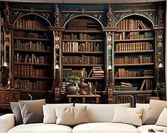 a living room filled with white couches and bookshelves