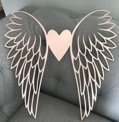 the back of a couch with an angel heart cut out of it's wings