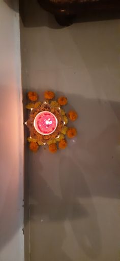 an orange and pink object sitting on top of a white wall