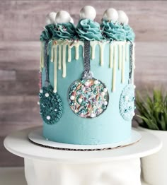 a blue cake decorated with sprinkles and decorations