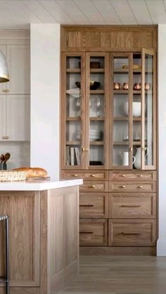 a kitchen with wooden cabinets and white counter tops