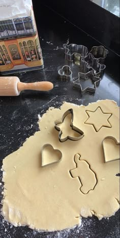 the cookie cutters are next to some dough