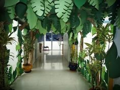 the hallway is decorated with green plants and potted plants