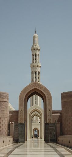 a large building with a clock tower in the middle of it's front entrance