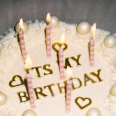 a birthday cake with lit candles on it