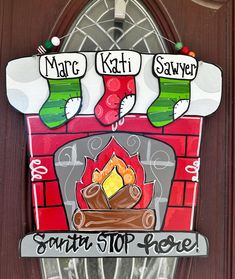 a christmas sign hanging on the side of a wooden door that says, marc kati saver santa stop here