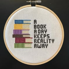 a cross stitch pattern with the words a book a day keeps reality away