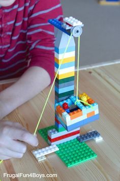 a child is playing with legos on the table