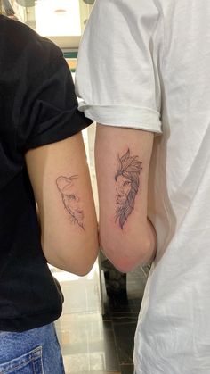 two people with tattoos on their arms