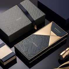 the packaging design is black, gold and silver with geometric patterns on it's sides